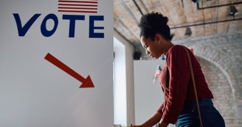 African American female citizen voting at polling