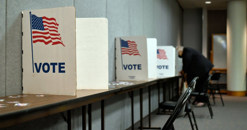 An elderly woman filling in her ballot