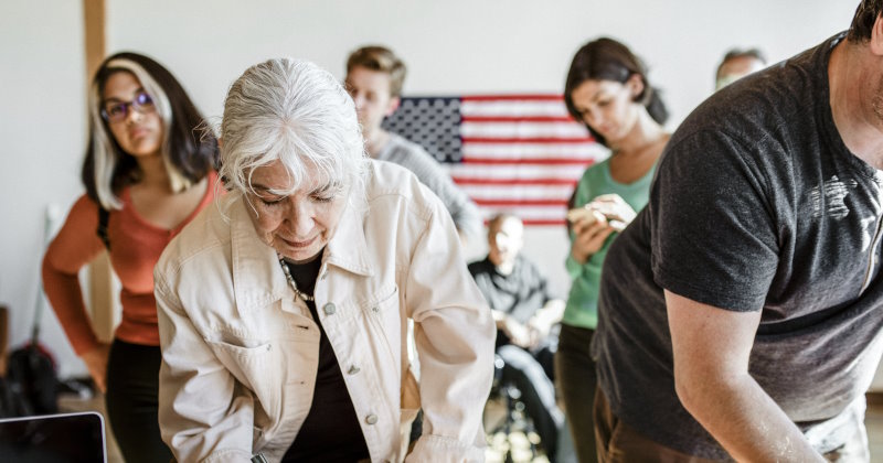 Diverse people queuing at a polling place