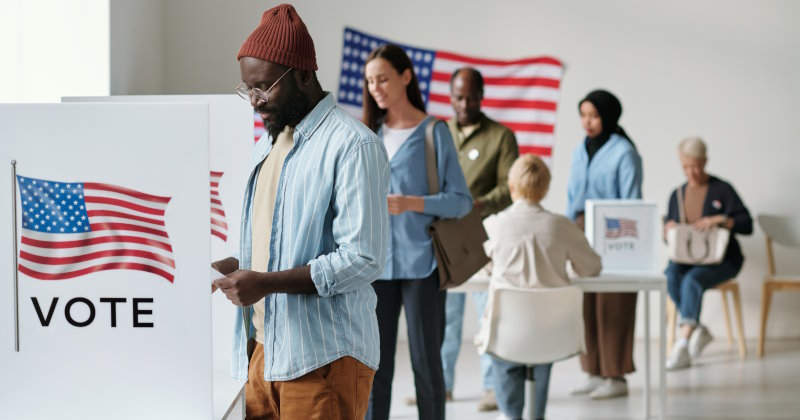 Group of young multicultural voters standing in queue