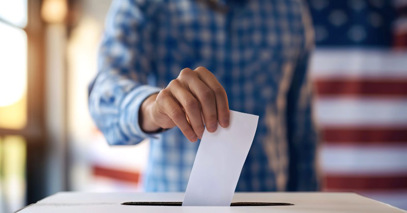 person depositing voting paper in ballot box.jpg